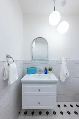 a white bathroom with a sink and a mirror at Prague Days - Apartments with AC in Vinohrady in Prague