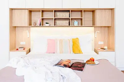 a bed with a book and a plate of food on it at Prague Days - Two Bedroom Apartment with AC next to National Theatre in Prague