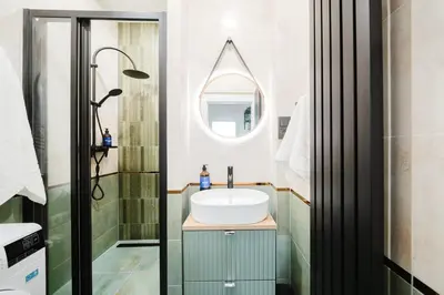 a bathroom with a sink and a mirror at Prague Days - Two Bedroom Apartment with AC next to National Theatre in Prague