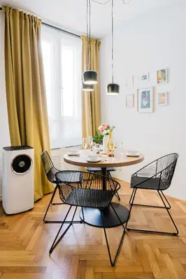 a dining room with a table and chairs at Prague Days - Two Bedroom Apartment with AC next to National Theatre in Prague