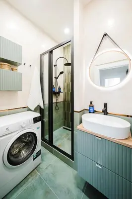 a bathroom with a washing machine and a sink at Prague Days - Two Bedroom Apartment with AC next to National Theatre in Prague