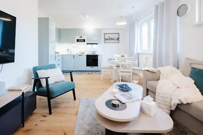 a living room with a couch and a table at Prague Days - One Bedroom Apartment with AC and Workspace in Holešovice in Prague