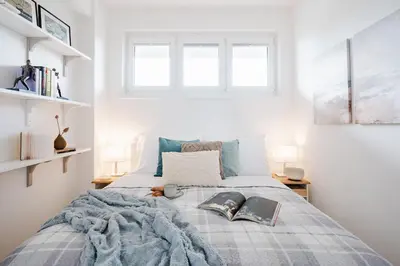 a bedroom with a bed with two books on it at Prague Days - One Bedroom Apartment with AC and Workspace in Holešovice in Prague
