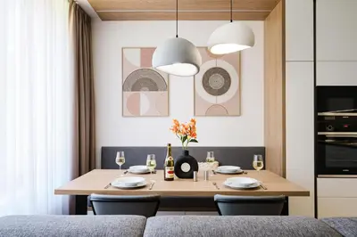a dining room with a table and a couch at Prague Days - One Bedroom Apartment with Garage Parking in Smíchov City in Prague