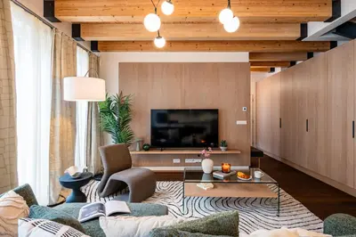 a living room with a couch and a tv at Prague Days - Luxurious 3BDR Maisonette w AC & Balcony & Desk in Prague
