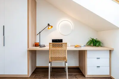 an attic room with a desk and a chair at Prague Days - Luxurious 3BDR Maisonette w AC & Balcony & Desk in Prague