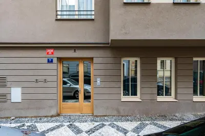 a building with a door with a car in it at Prague Days - Luxurious 3BDR Maisonette w AC & Balcony & Desk in Prague