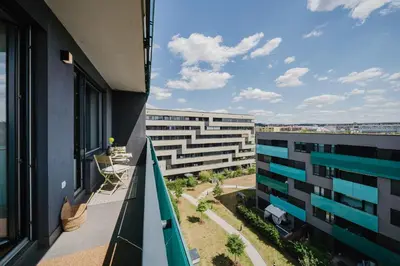 a balcony with a view of a building at Prague Days - Family Friendly One-Bedroom Apartment with Balcony, TV & Netflix in Holešovice in Prague