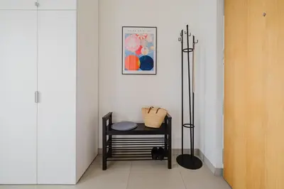a room with a table and a picture on the wall at Prague Days - Family Friendly One-Bedroom Apartment with Balcony, TV & Netflix in Holešovice in Prague