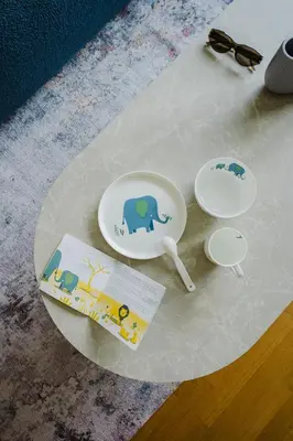 a table with two plates with elephants on it at Prague Days - Family Friendly One-Bedroom Apartment with Balcony, TV & Netflix in Holešovice in Prague