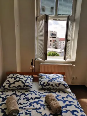 a bedroom with two beds in front of a window at Comfortable 2 Bedroom Flat Free Parking Shared Kitchen in Prague