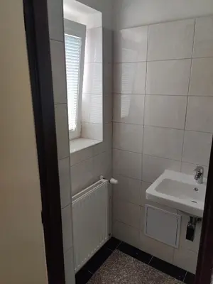 a small bathroom with a sink and a mirror at Comfortable 2 Bedroom Flat Free Parking Shared Kitchen in Prague