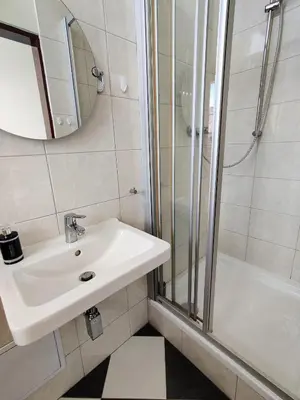a bathroom with a sink and a shower at Cozy Flat at Žižkov & Free Parking in Prague