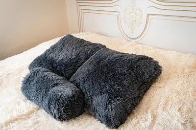 a black blanket laying on top of a bed at Golden Heart Residence in Prague