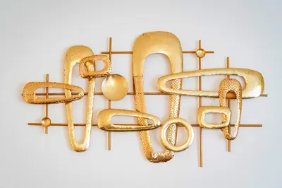 a bunch of gold jewelry hanging on a wall at Golden Heart Residence in Prague