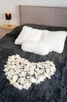 a heart made out of shells on a bed at Golden Heart Residence in Prague