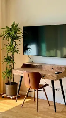 a desk with a large television on top of it at Urban studio with balcony in Prague