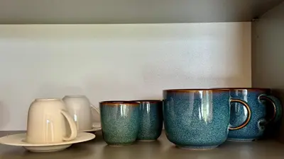 four blue coffee cups sitting on a table at Urban studio with balcony in Prague