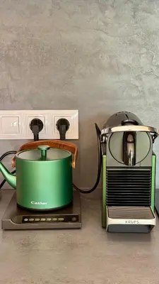 a green slow cooker sitting on top of a toaster at Urban studio with balcony in Prague