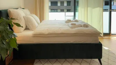a bed with towels on it in a bedroom at Urban studio with balcony in Prague