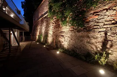 a brick wall with lights on the side of it at Penzion Dobré Časy in Poděbrady