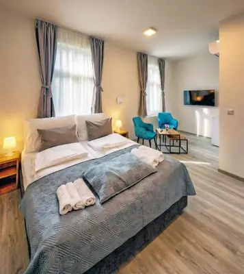 a bedroom with a large bed with two towels on it at Prague Urban Apartments 48 in Prague