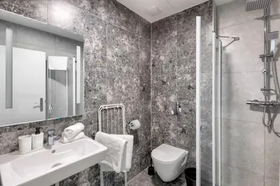a bathroom with a sink and a toilet and a shower at Prague Urban Apartments 48 in Prague
