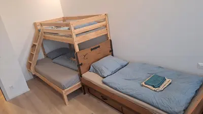 a bedroom with a bunk bed and a ladder at Apartment near O2 Arena in Prague