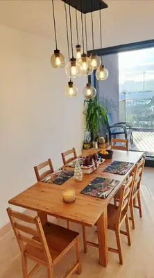 a kitchen with white cabinets and a stainless steel refrigerator at Apartment near O2 Arena in Prague