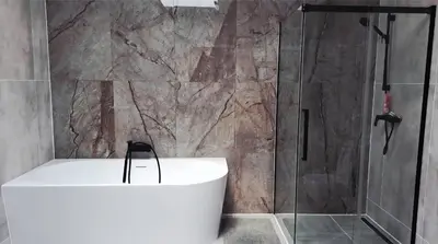 a bathroom with a shower and a white bath tub at Apartment near O2 Arena in Prague