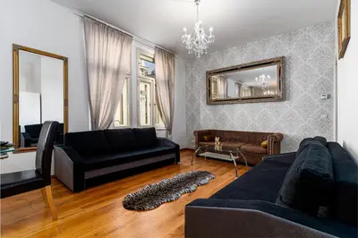a living room with a couch and a mirror at Premium Dog Suite in Prague