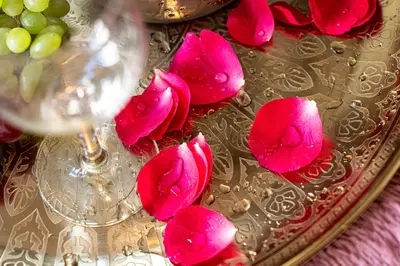 a plate with pink roses and a glass of wine at Premium Dog Suite in Prague