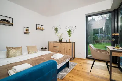 a bedroom with a bed and a desk and a window at Modern Nature Retreat w Pool, PS5 & Hot Tube in Sázava