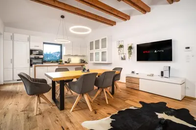 a kitchen and dining room with a table and chairs at Modern Nature Retreat w Pool, PS5 & Hot Tube in Sázava