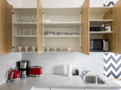 a kitchen counter with a sink and a microwave at Peaceful Apartment next to Jubilee Synagogue in Prague