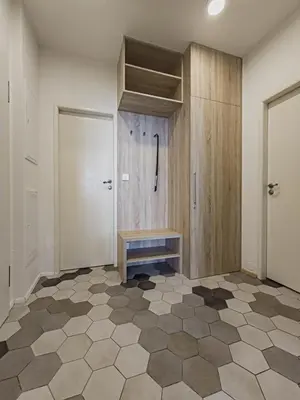a bathroom with a bench on a tiled floor at Peaceful Apartment next to Jubilee Synagogue in Prague