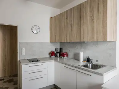 a kitchen with white cabinets and a sink at Peaceful Apartment next to Jubilee Synagogue in Prague
