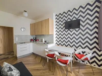 a kitchen with a table and chairs in a kitchen at Peaceful Apartment next to Jubilee Synagogue in Prague