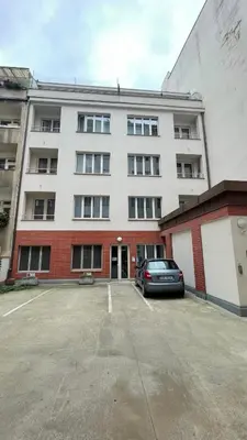 a car parked in a parking lot in front of a building at Peaceful Apartment next to Jubilee Synagogue in Prague