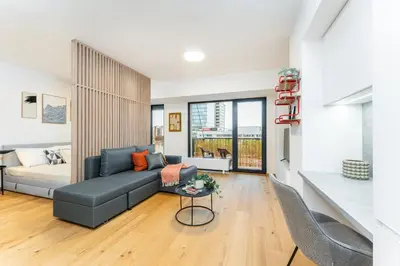 a living room with a couch and a table at Rentero Fresh Apartment next to Prague City Center in Prague