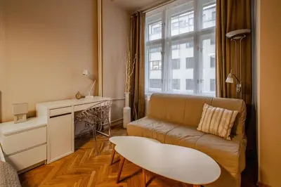 a living room with a couch and a table at Wenceslas Sq 3BDR Apartment in Prague