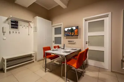 a dining room with orange chairs and a table at Wenceslas Sq 3BDR Apartment in Prague