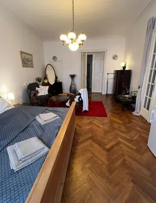 a living room with a large bed and a living room at Štěpánská noc A in Prague