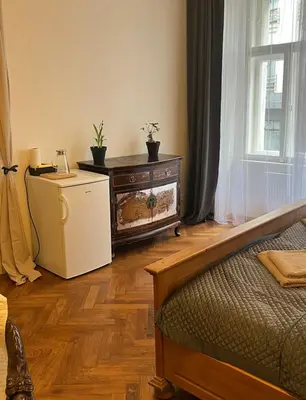 a room with a bed and a dresser and a window at Štěpánská noc A in Prague