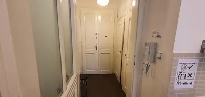 a hallway with a white door in a room at Tower Apartment in Prague