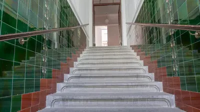 a staircase in a building with green tiles at Tower Apartment in Prague
