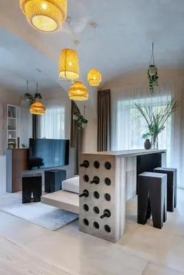 a living room with a table and a tv at Moderní a útulné studio na statku z roku 1880 in Prague