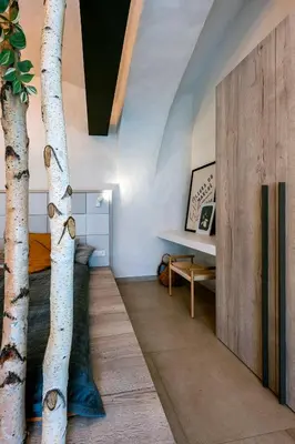 a room with a table and a tree in it at Moderní a útulné studio na statku z roku 1880 in Prague