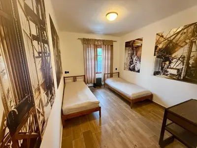 a living room with two beds and a table at Černokostelecký pivovar in Kostelec nad Černými Lesy