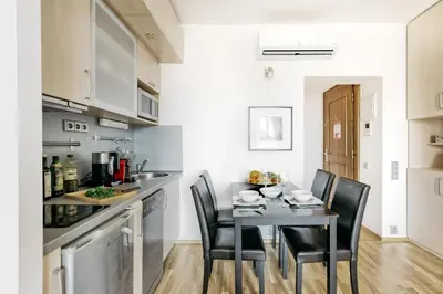 a kitchen with a table and chairs in a room at LIL Apartment with Tyn Cathedral View, Parking & AC in Prague